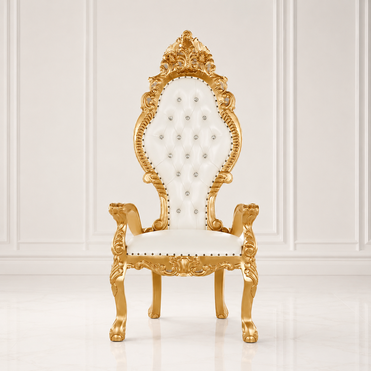 An ornate high-back throne chair with a carved gold frame and white tufted upholstery, set against a white paneled wall and floor.