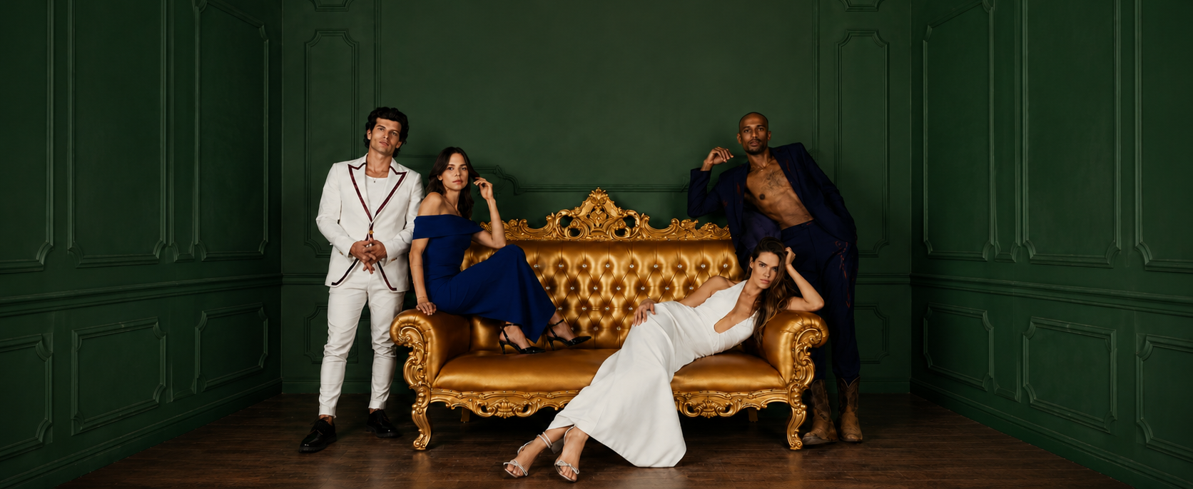 Luxury gold loveseat with four elegantly dressed models in a dark green paneled room, showcasing ornate royal-style seating and sophisticated event furniture.