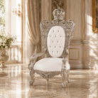 An ornate royal-style baroque armchair with a silver carved frame and a tufted white upholstered backrest, set in a luxurious cream-colored room with marble floors and gold accents.